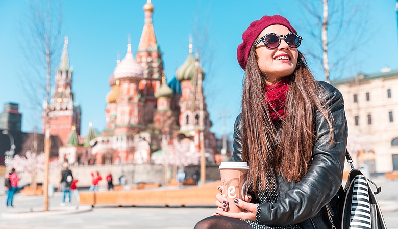 Young woman in Moscow Red Square, with Saint Basil cathedral in background