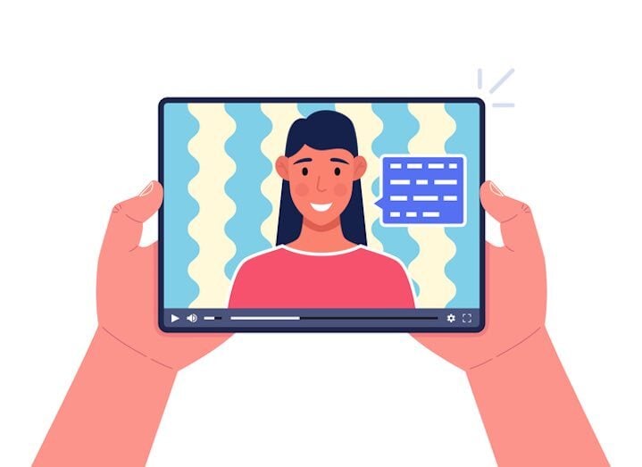 Hands holding tablet with remote interpreter video and captions, illustrating VRI troubleshooting