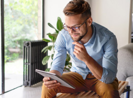 man looking at tablet on couch