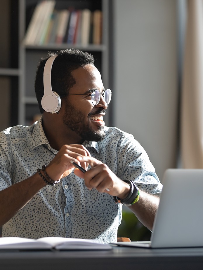 man on laptop with headphones on