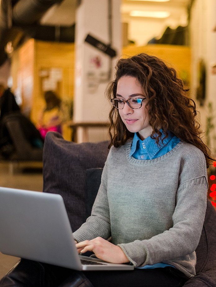 woman on couch using laptop