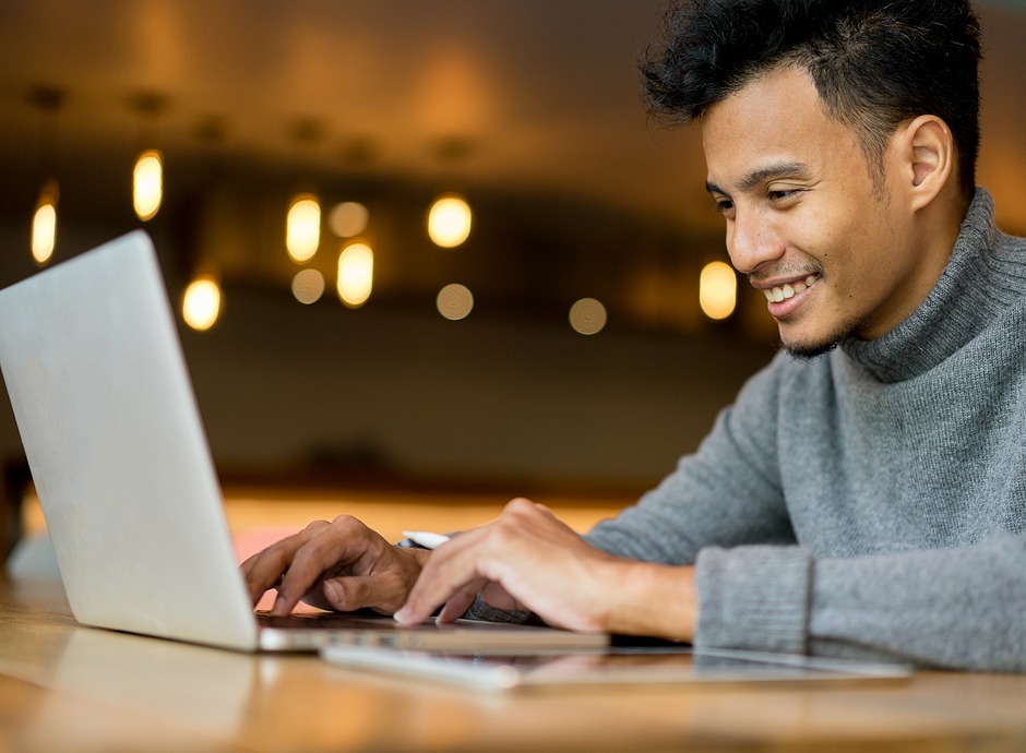 man smiling at computer