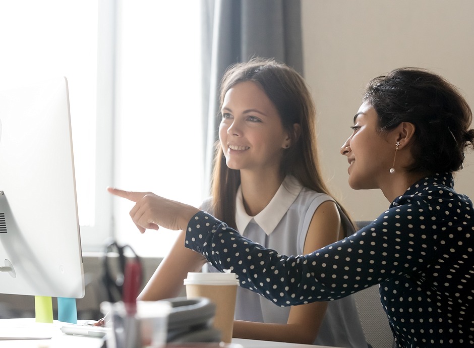 two friends looking at computer