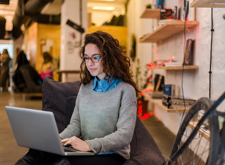 woman on couch using laptop