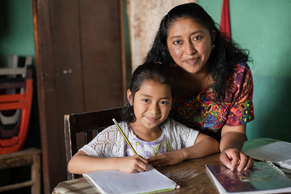 spanish mom helping daughter write in spanish