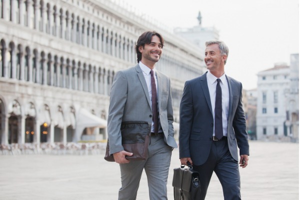 italian businessmen walking across st marks square in venice