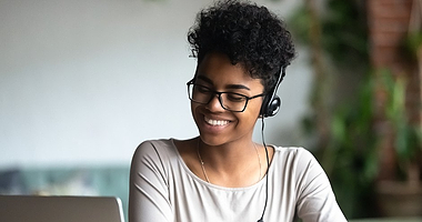 woman-smiling-while-looking-at-laptop-380x200